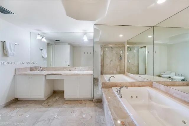 a bathroom with a sink tub shower and a mirror