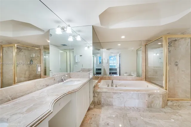 a large spacious bathroom with a large tub shower and sink