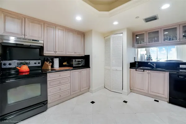 a kitchen with stainless steel appliances kitchen island granite countertop a stove a sink and a microwave