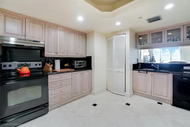 a kitchen with stainless steel appliances kitchen island granite countertop a stove a sink and a microwave