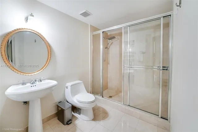 a bathroom with a toilet sink and shower
