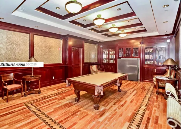 a room with stainless steel appliances lots of wooden furniture