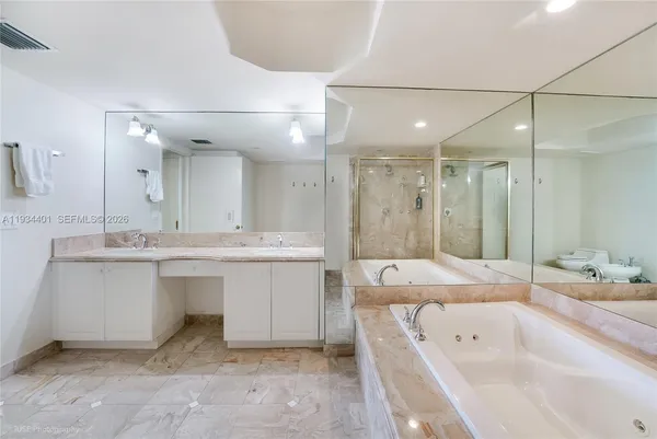 a bathroom with a sink tub shower and a mirror