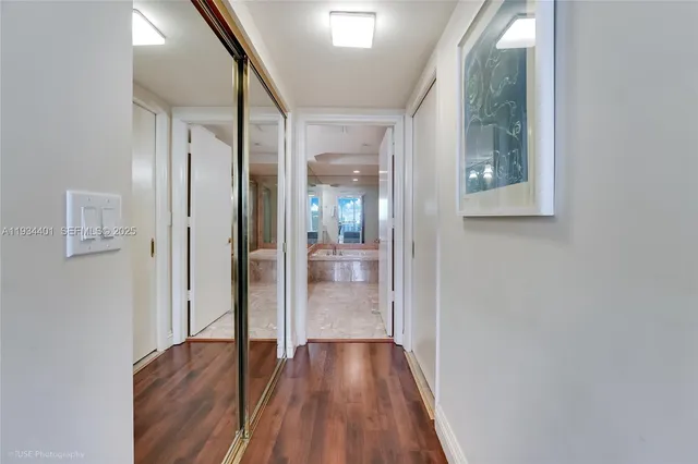 a view of a hallway with wooden floor