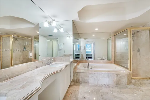 a large spacious bathroom with a large tub shower and sink