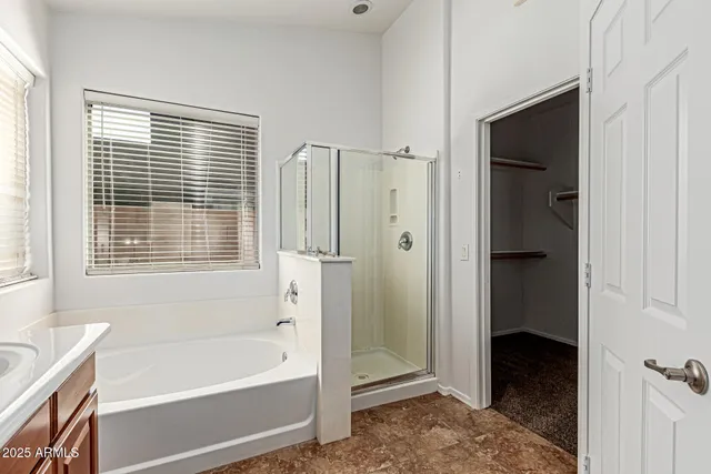 a bathroom with a bathtub and a shower