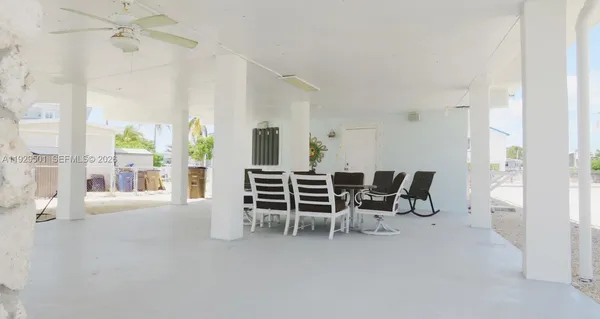 a dining room with furniture and a floor to ceiling window