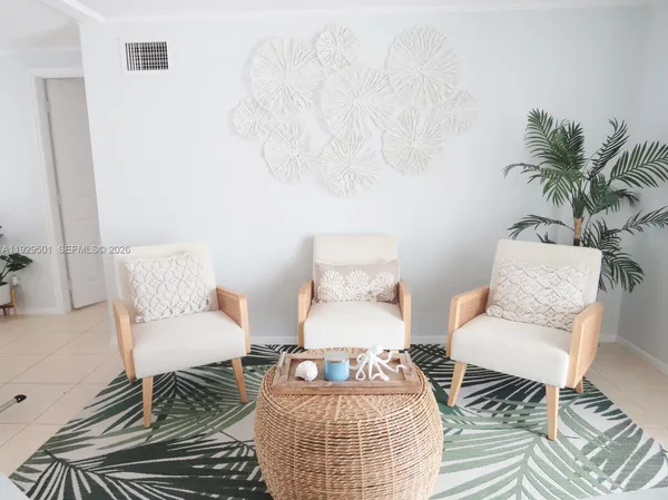 a living room with furniture and a potted plant