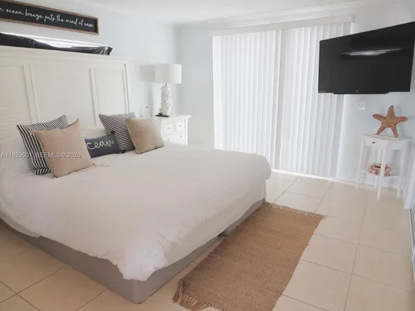 a large white bed in a white room