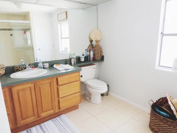 a bathroom with a sink a toilet and mirror