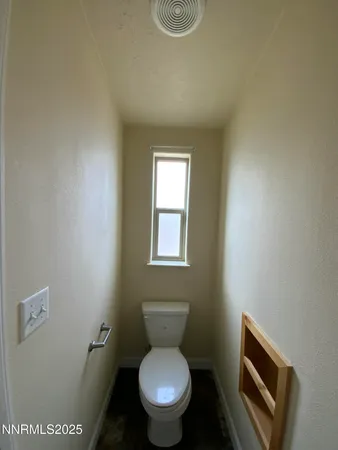 a white toilet sitting next to a bathroom sink