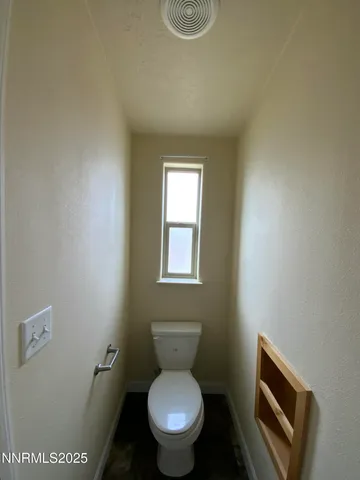 a white toilet sitting next to a bathroom sink