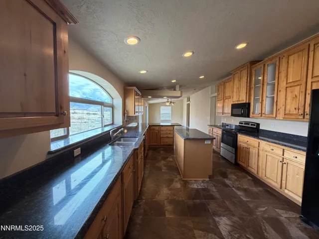 a kitchen with a large window in it and kitchen island