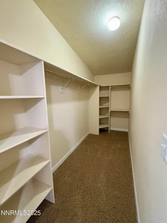 a view of an empty room with a closet
