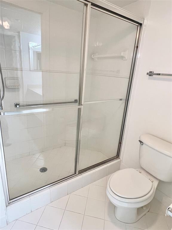 7763 Southampton Terrace, Unit 411 Tamarac, FL 33321 - Photo 11 of 33 a bathroom with a toilet and a shower