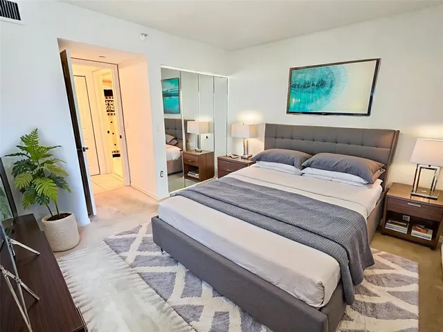 a spacious bedroom with a bed and a couch