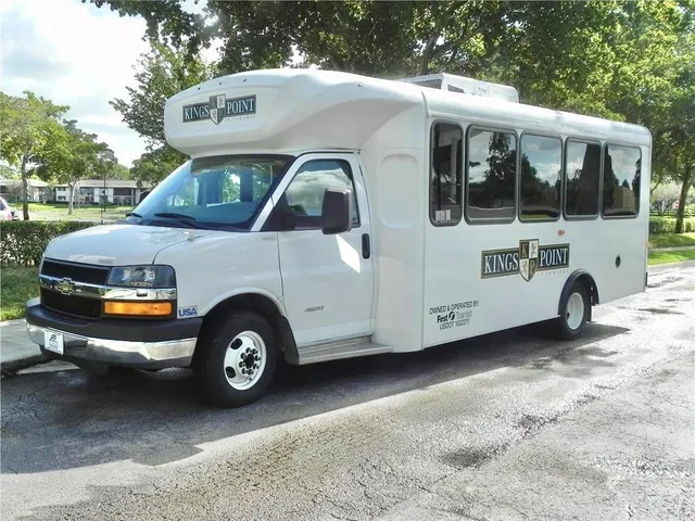 a front view of a house with parking space