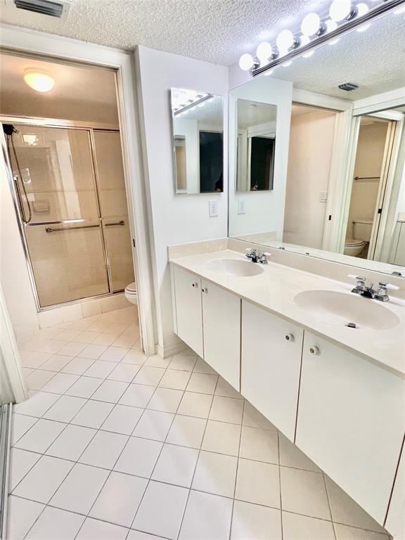 7763 Southampton Terrace, Unit 411 Tamarac, FL 33321 - Photo 9 of 33 a bathroom with a sink a mirror and a shower