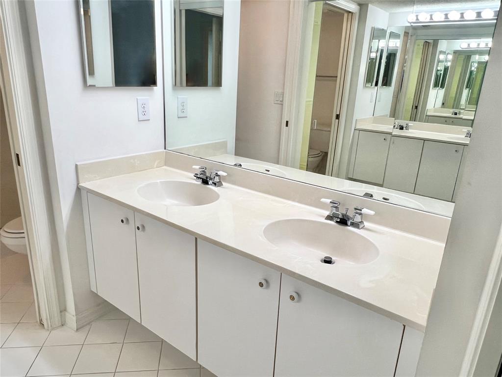 7763 Southampton Terrace, Unit 411 Tamarac, FL 33321 - Photo 10 of 33 a bathroom with a sink and a mirror