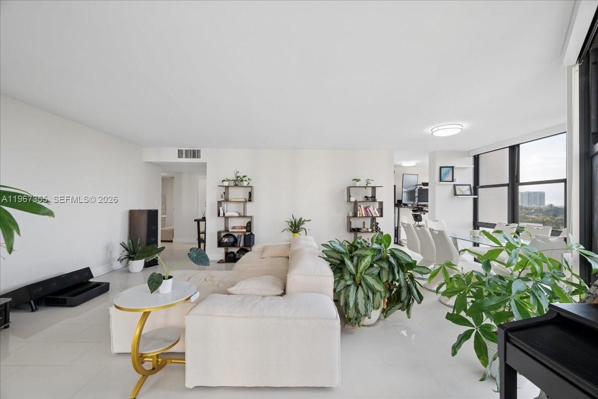 1915 Brickell Avenue, Unit 801 Miami, FL 33129 - Photo 1 of 37 a living room with furniture potted plant and a window