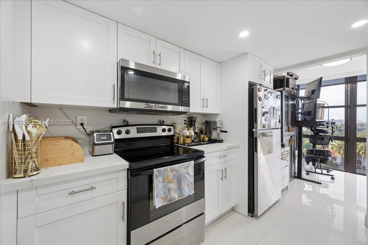 1915 Brickell Avenue, Unit 801 Miami, FL 33129 - Photo 11 of 37 a kitchen with a refrigerator stove and microwave