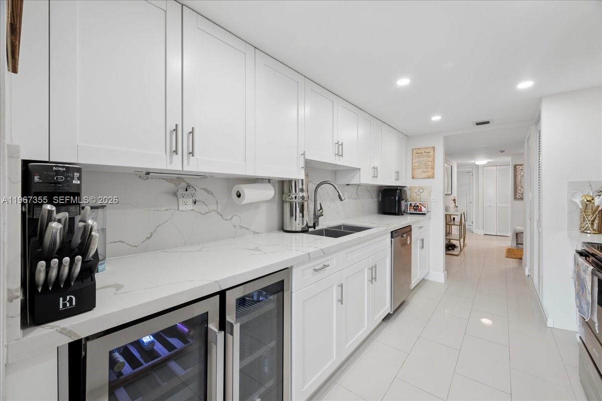 1915 Brickell Avenue, Unit 801 Miami, FL 33129 - Photo 12 of 37 a kitchen with stainless steel appliances sink refrigerator and cabinets