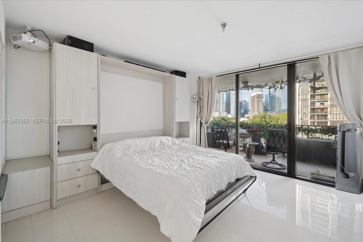1915 Brickell Avenue, Unit 801 Miami, FL 33129 - Photo 14 of 37 a bedroom with a large bed and a window