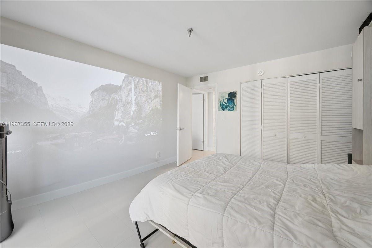 1915 Brickell Avenue, Unit 801 Miami, FL 33129 - Photo 15 of 37 a bedroom with a bed and a window