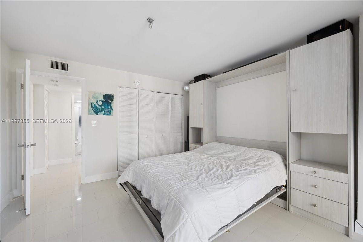 1915 Brickell Avenue, Unit 801 Miami, FL 33129 - Photo 16 of 37 a bedroom with a bed and a closet