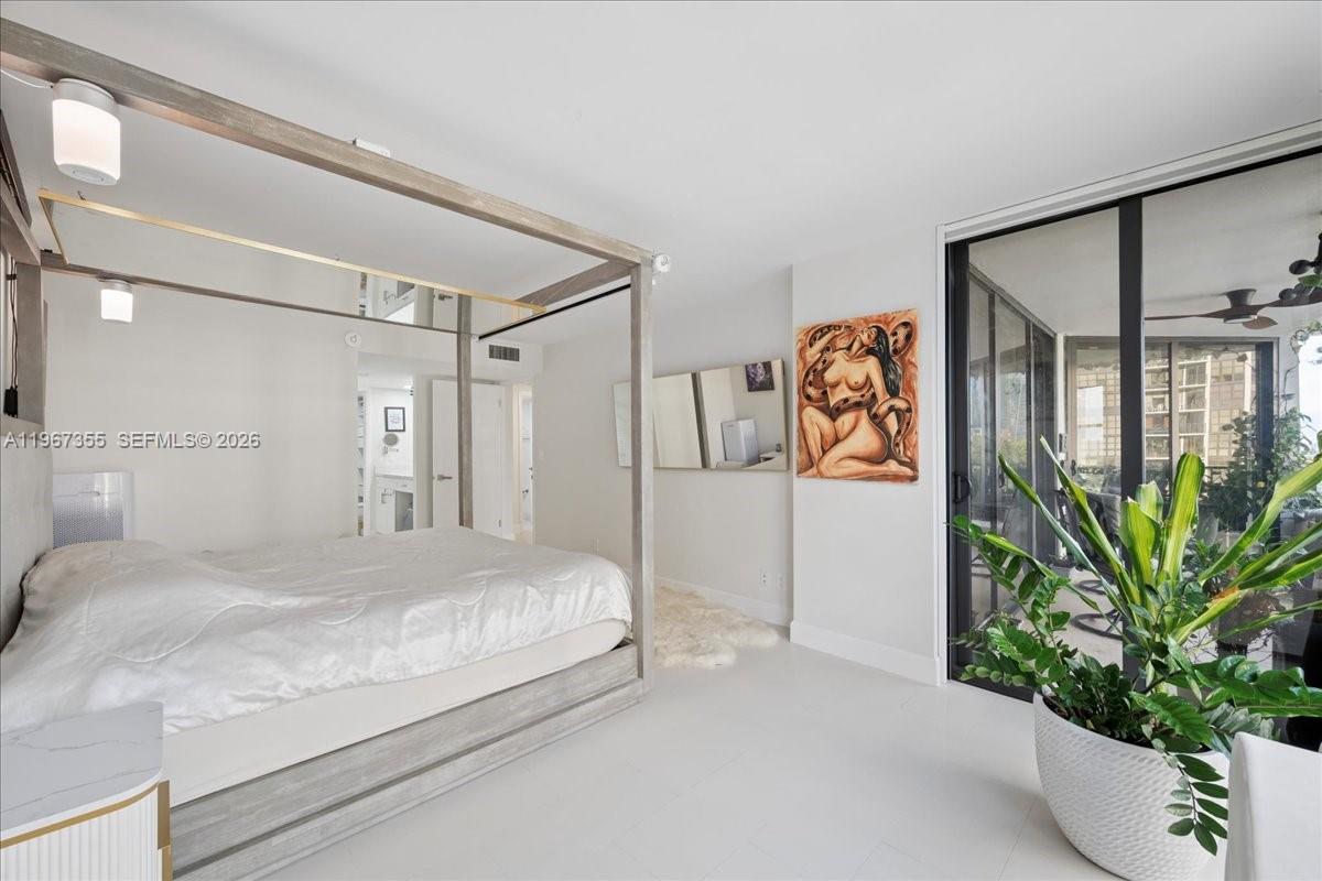 1915 Brickell Avenue, Unit 801 Miami, FL 33129 - Photo 19 of 37 a bedroom with a large bed and a potted plant