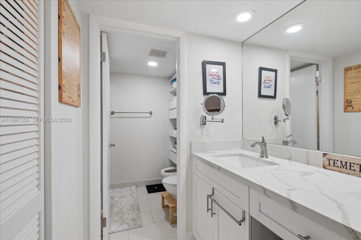 1915 Brickell Avenue, Unit 801 Miami, FL 33129 - Photo 20 of 37 a bathroom with a sink a toilet and shower