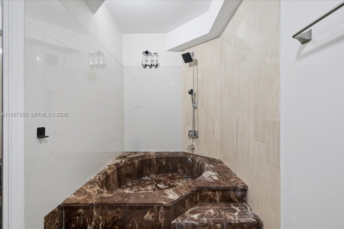 1915 Brickell Avenue, Unit 801 Miami, FL 33129 - Photo 21 of 37 a bedroom with a bed and a window