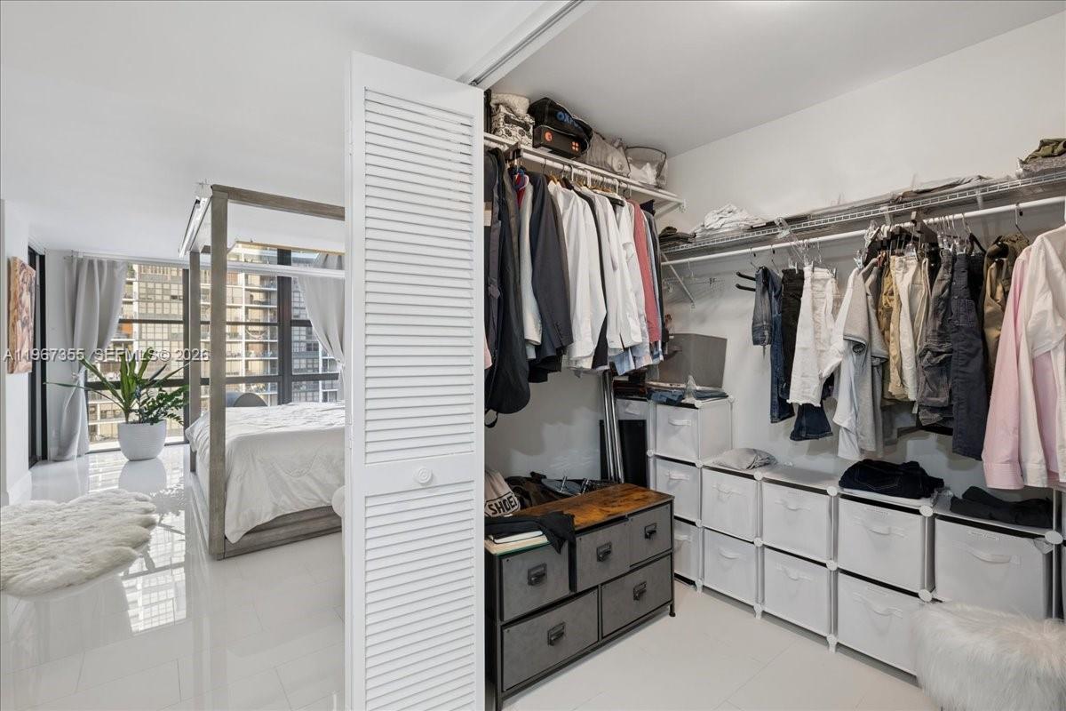 1915 Brickell Avenue, Unit 801 Miami, FL 33129 - Photo 22 of 37 a view of walk in closet with clothes and shoes