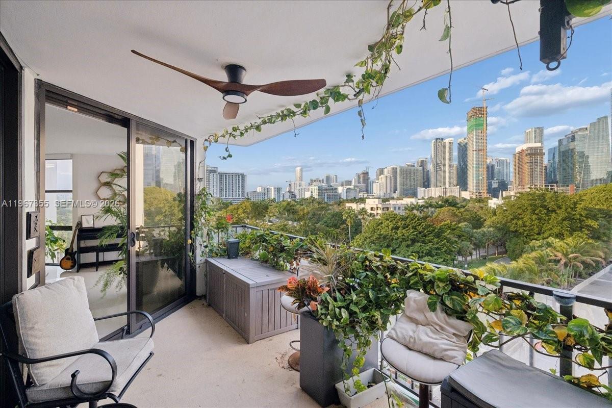 1915 Brickell Avenue, Unit 801 Miami, FL 33129 - Photo 25 of 37 a room with lots of potted plants and more windows