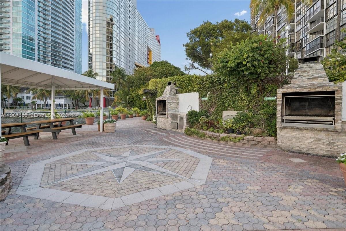 1915 Brickell Avenue, Unit 801 Miami, FL 33129 - Photo 26 of 37 a view of a patio with a table and chairs under an umbrella