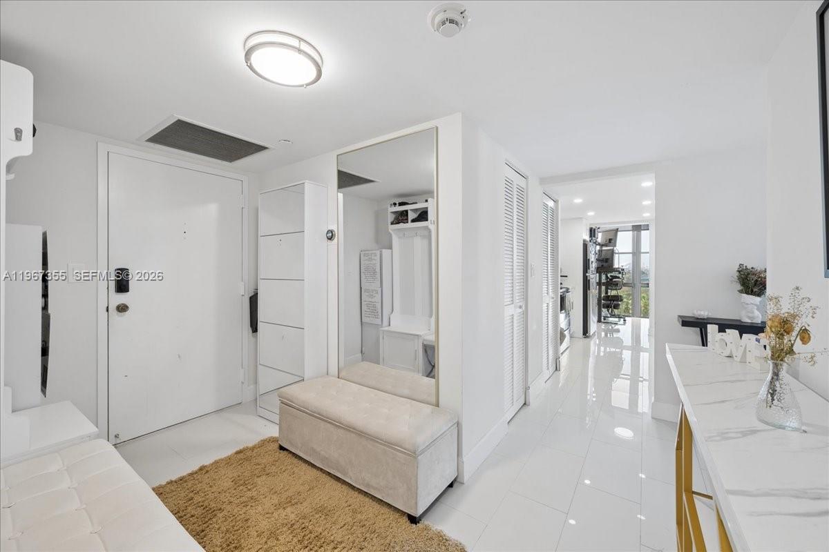 1915 Brickell Avenue, Unit 801 Miami, FL 33129 - Photo 6 of 37 a living room with furniture and a rug