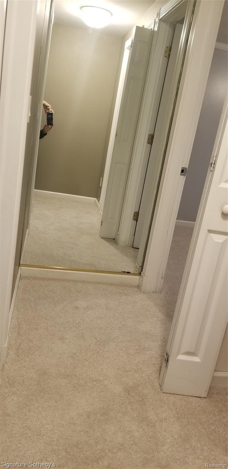67976 Van Dyke Road, Unit 9 Washington, MI 48095 - Photo 20 of 20 Floor to ceiling mirror at end of upstairs hall
