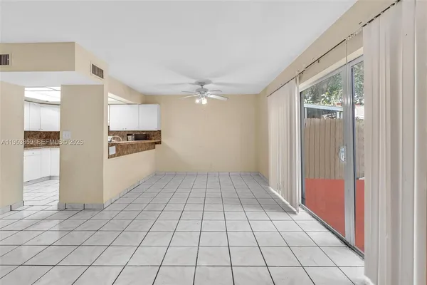 a view of a kitchen with a sink and a refrigerator cabinets