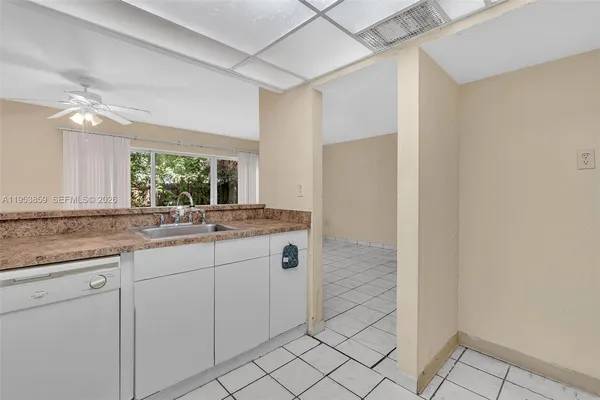 a white toilet sitting next to a white wall