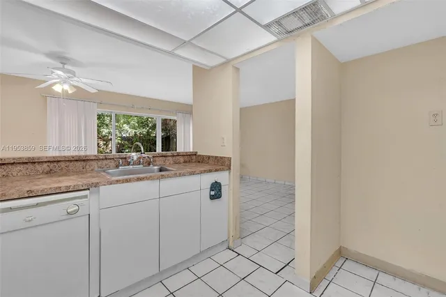 a white toilet sitting next to a white wall