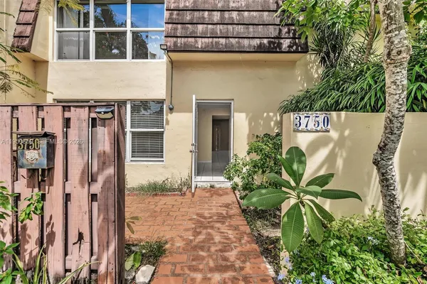 a view of a street with potted plants