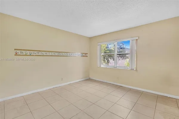 a view of a road with plants and trees