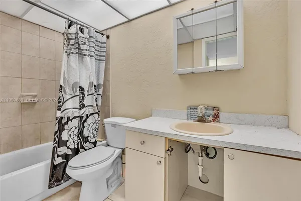 a view of a kitchen with wooden floor and a refrigerator