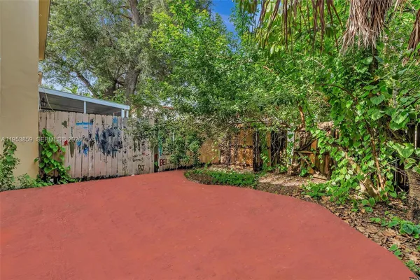 an aerial view of a house with a yard basket ball court and outdoor seating