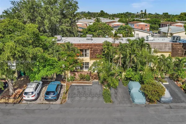 an aerial view of residential building with green space