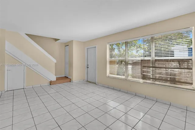 a view of an empty room with a window