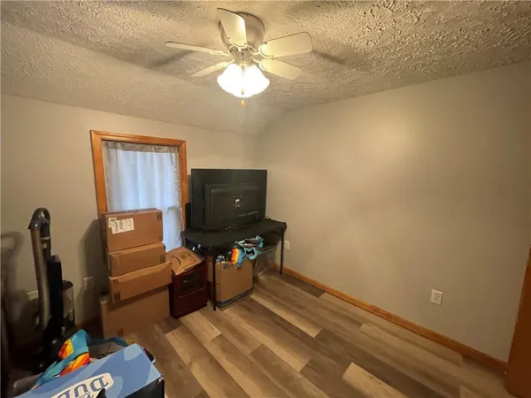 a room with a table chairs and wooden floor