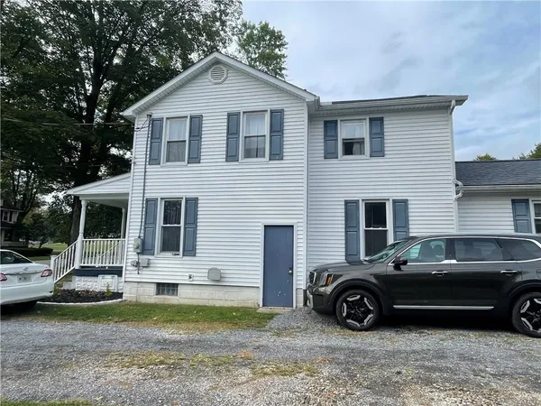 a front view of a house with a garden