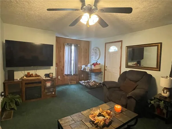 a view of a dining room with furniture and a mirror