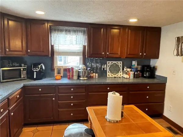 a view of bathroom with a refrigerator and a window